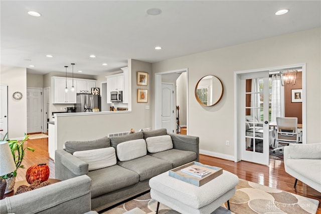 living room with french doors and light hardwood / wood-style floors