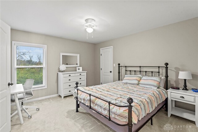 bedroom featuring ceiling fan and light colored carpet