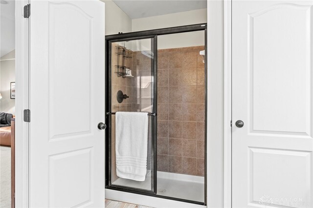 bathroom featuring a shower with shower door