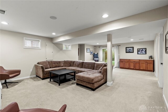 living room featuring light carpet and a wealth of natural light