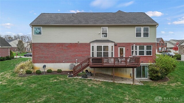 back of house with a lawn, central air condition unit, and a wooden deck