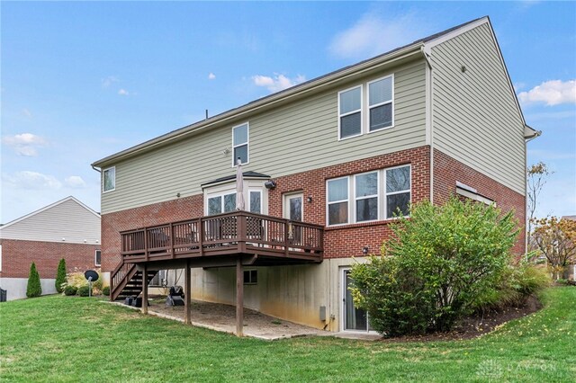 rear view of house featuring a deck and a yard