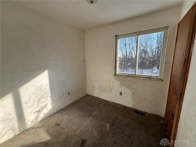 empty room with carpet floors and visible vents