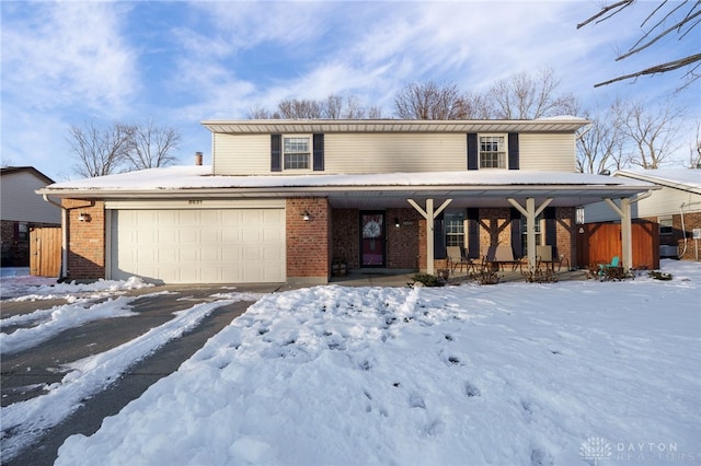 view of property featuring a garage and a porch