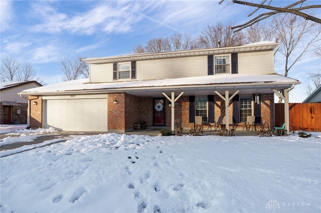 front of property featuring covered porch and a garage