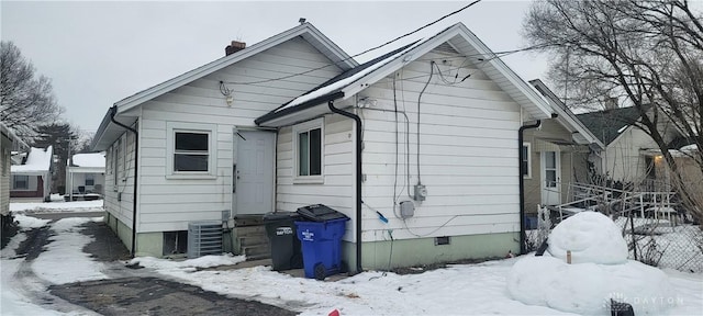 snow covered property featuring cooling unit