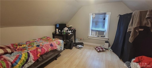 bedroom featuring lofted ceiling, cooling unit, and light hardwood / wood-style floors