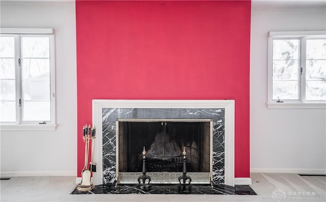 interior details featuring carpet and a high end fireplace