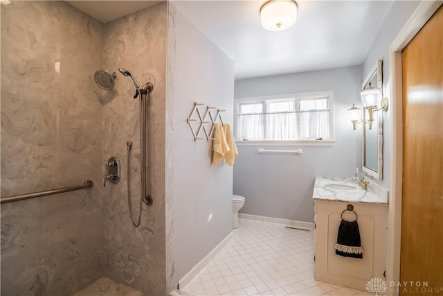 bathroom featuring toilet, vanity, tile patterned floors, and a tile shower