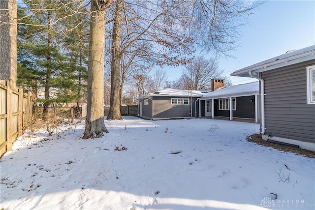 snowy yard with a storage unit