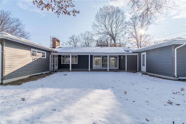 snow covered property featuring covered porch