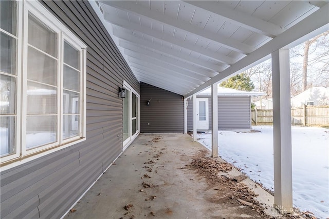 snow covered patio with an outbuilding