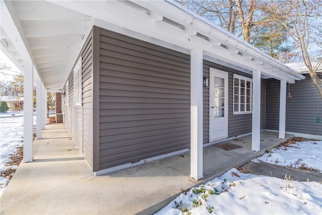 view of snow covered property entrance