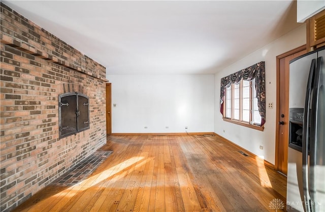 unfurnished living room with wood-type flooring