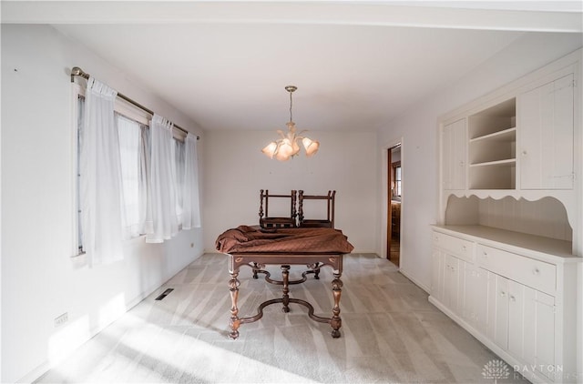 carpeted dining space featuring a notable chandelier