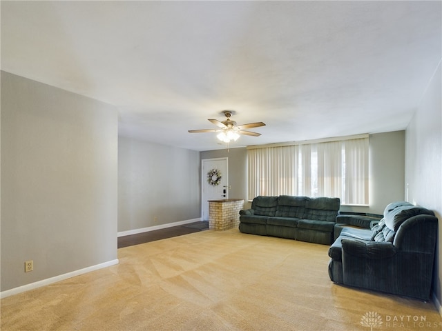 carpeted living room with ceiling fan