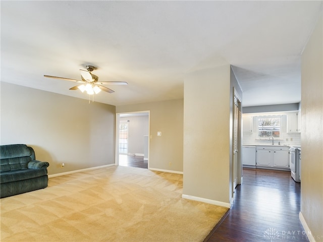 interior space with ceiling fan and light colored carpet