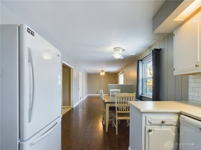 kitchen with white appliances, white cabinets, dark hardwood / wood-style flooring, tasteful backsplash, and ceiling fan