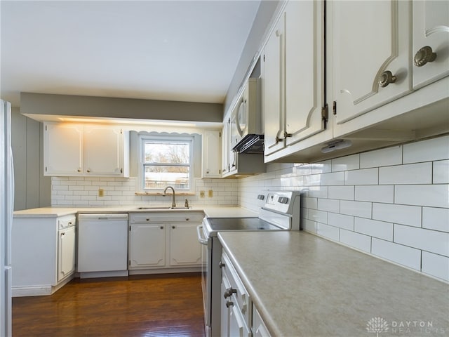 kitchen featuring backsplash, white appliances, dark hardwood / wood-style flooring, white cabinets, and sink