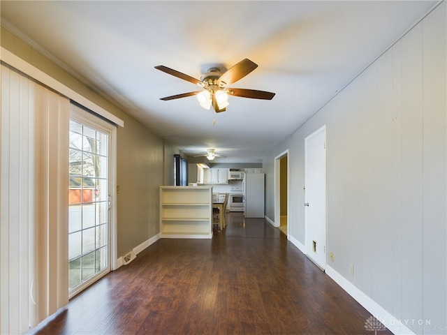 unfurnished living room with ceiling fan and dark wood-type flooring