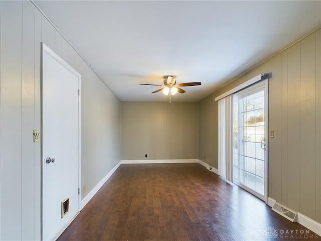 spare room with ceiling fan and dark hardwood / wood-style flooring