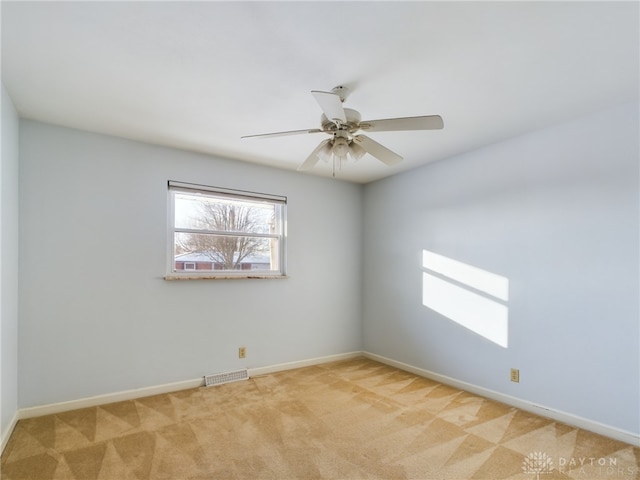 unfurnished room featuring ceiling fan and light carpet