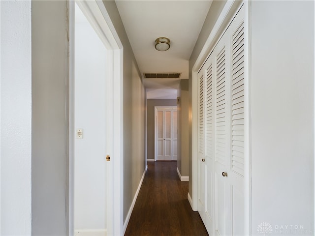 corridor featuring dark hardwood / wood-style flooring