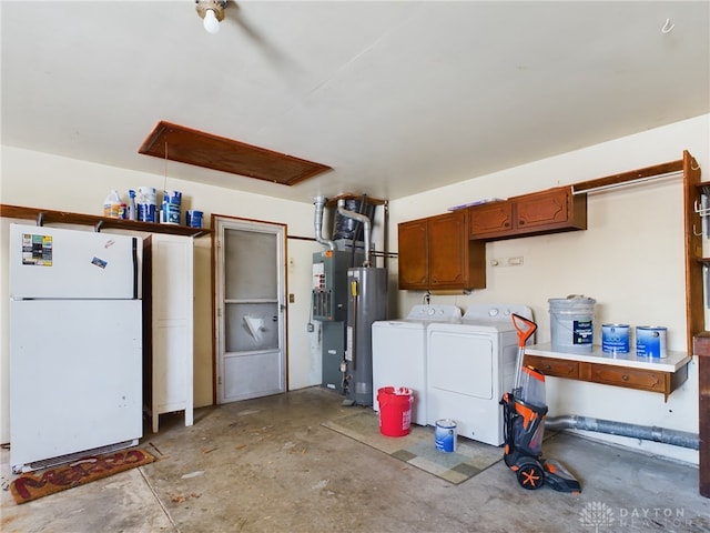 garage featuring water heater, separate washer and dryer, and white fridge