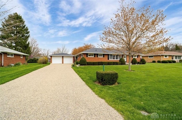 ranch-style house featuring a front lawn and a garage