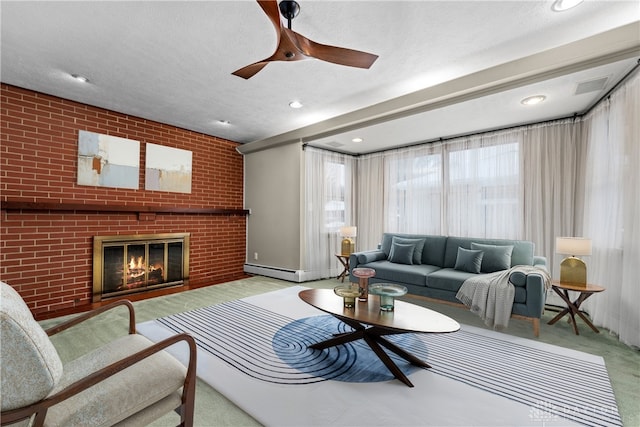 living room with ceiling fan, a baseboard radiator, a textured ceiling, and a fireplace