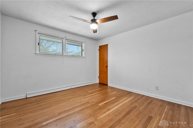 empty room with ceiling fan, baseboard heating, and light wood-type flooring