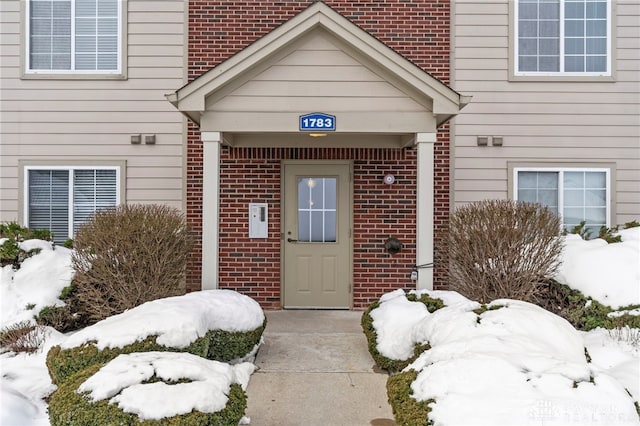 view of snow covered property entrance