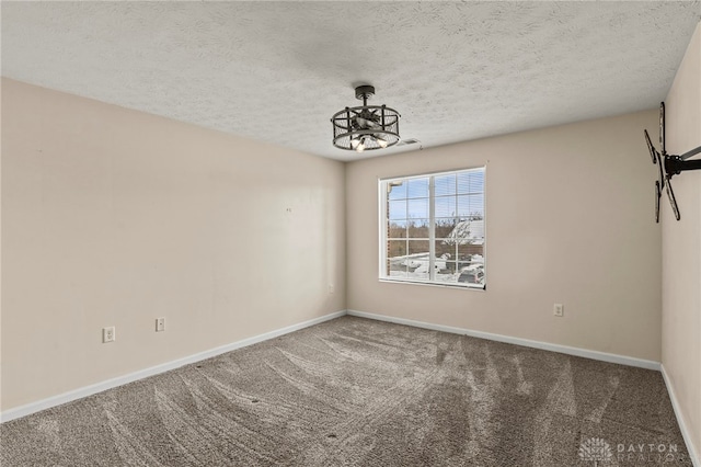 empty room with ceiling fan, carpet, and a textured ceiling