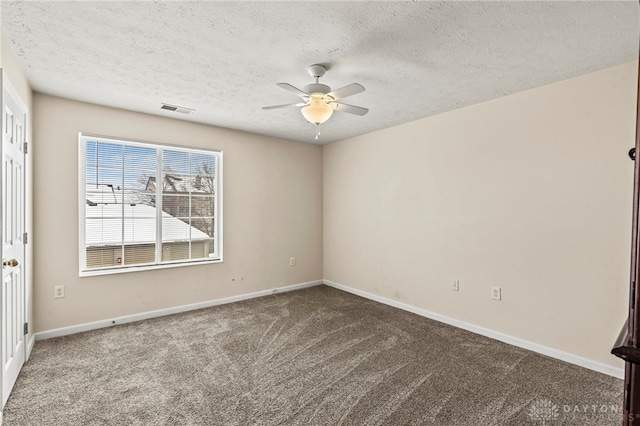 spare room featuring a textured ceiling, ceiling fan, and carpet flooring