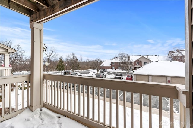 view of snow covered back of property