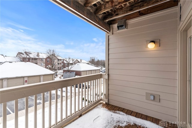 view of snow covered back of property