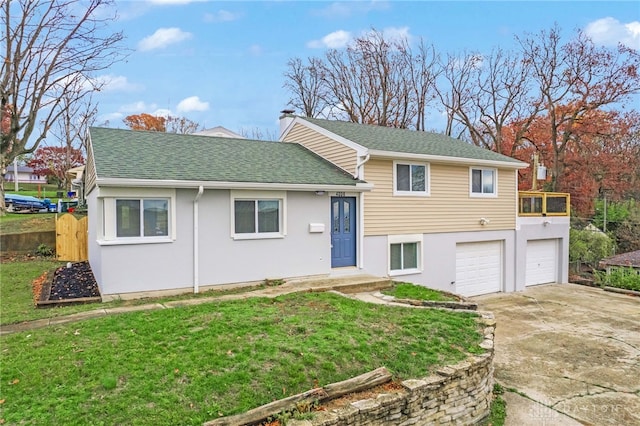 split level home featuring a front lawn and a garage