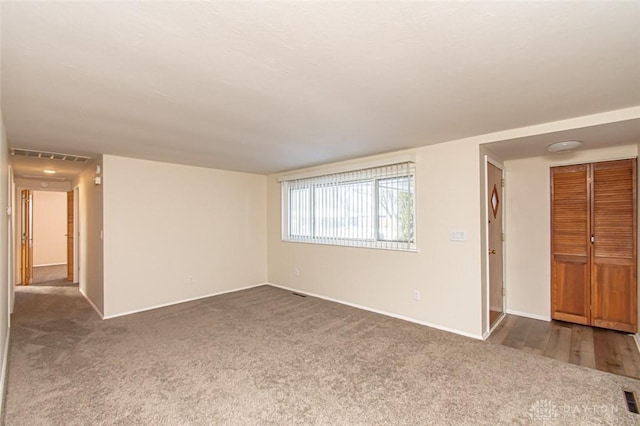 empty room featuring dark colored carpet