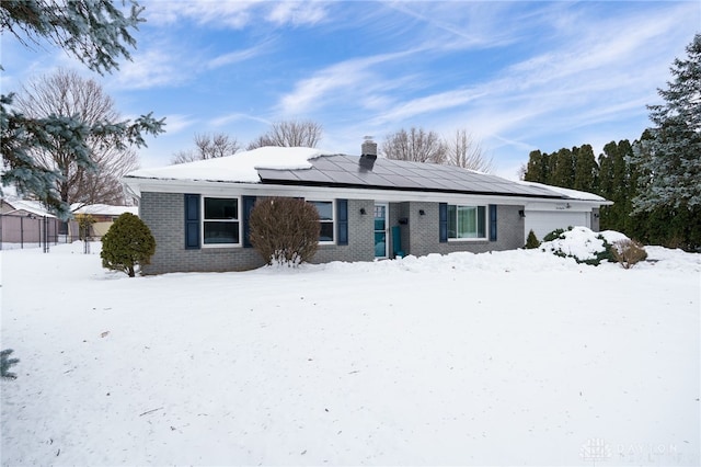 view of front of house featuring a garage and solar panels