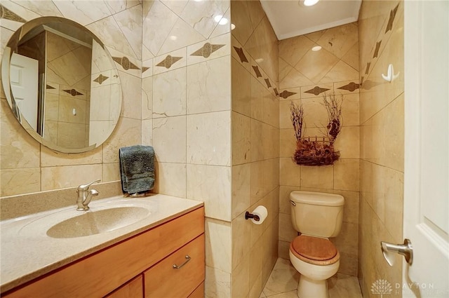 bathroom featuring toilet, tile patterned flooring, tile walls, ornamental molding, and vanity