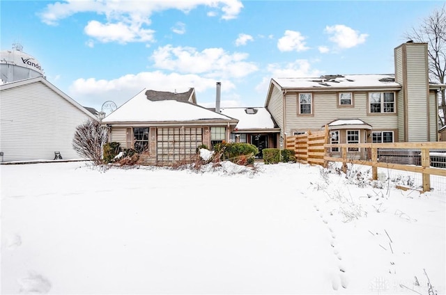 view of snow covered back of property