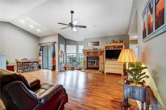 living room with vaulted ceiling, ceiling fan, and hardwood / wood-style flooring