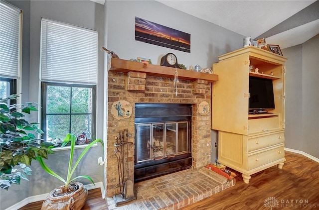 details featuring a brick fireplace and hardwood / wood-style floors