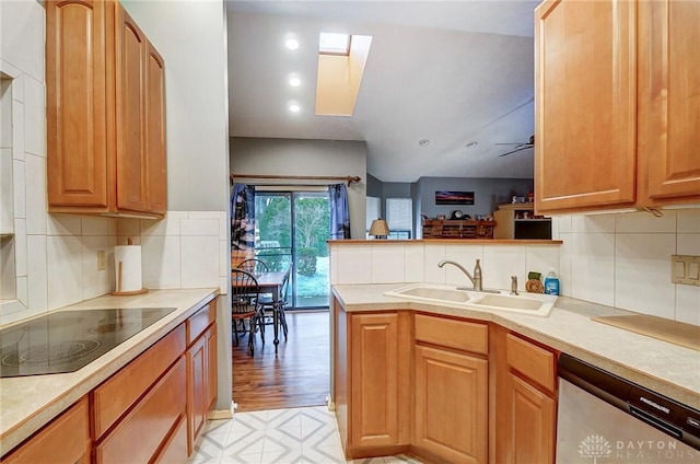 kitchen with dishwasher, black electric stovetop, sink, kitchen peninsula, and ceiling fan