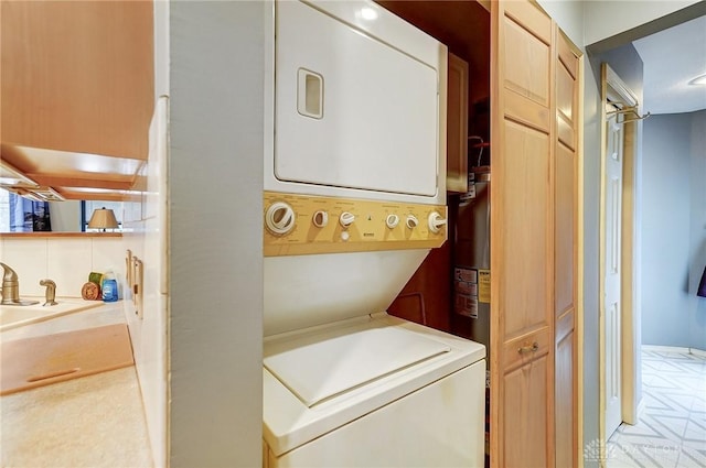 washroom featuring sink and stacked washer and dryer