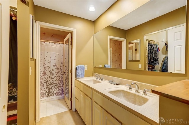 bathroom featuring tile patterned floors, vanity, and walk in shower