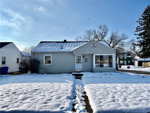 view of snow covered rear of property