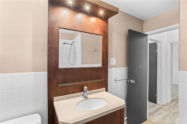 bathroom with vanity, tile walls, toilet, walk in shower, and hardwood / wood-style flooring