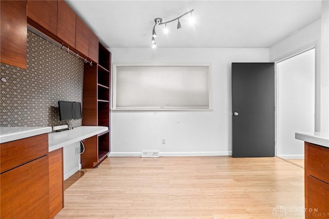 unfurnished office with light wood-type flooring