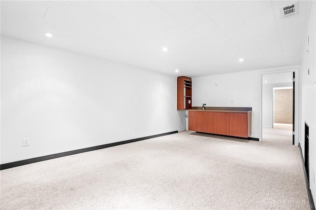 unfurnished living room featuring light colored carpet